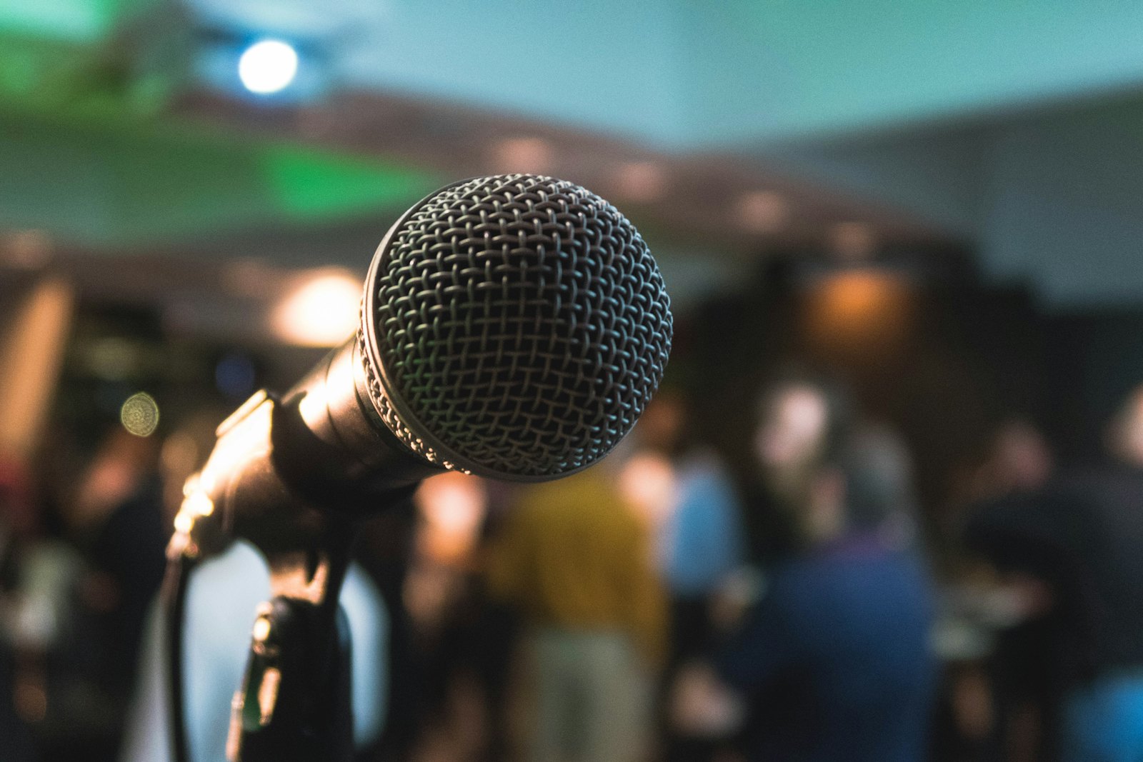 Stage microphone in front of a blurred audience